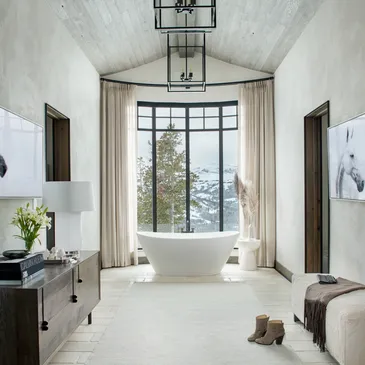 A bathroom with a large window and a tub.